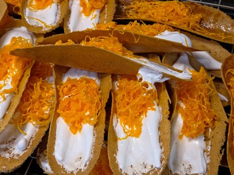 Traditional Thai Crispy Pancakes (Khanom Buang) with Meringue and Golden Egg Yolk Threads. Close Up Image.