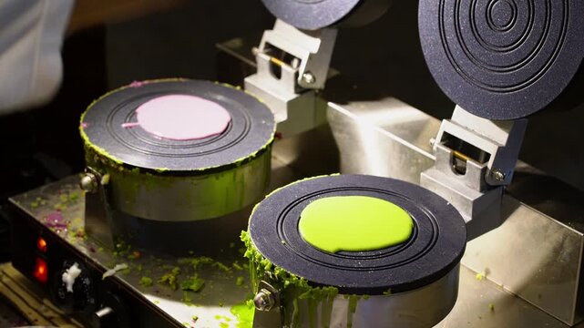 Artisanal vendor handcrafting traditional Thai fresh coconut crepes (Thong Muan Sot) at a vibrant Thailand night market with steam rising from hot circular griddles in 4K.