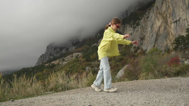 Dynamic Gymnastics Cartwheel By Athletic Girl On Dramatic Mountain Cliff Road Vertical video.