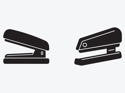 Two black staplers side by side one open and one closed office supplies