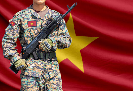 Vietnam flag with soldier holding assault rifle