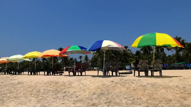 The beach with colorful umbrellas and chairs installed for tourists | Marari Beach, Alappuzha, Kerala, India