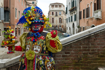 Fototapeta premium Venice, Italy - February 16, 2026 - People dressed in masks for the Venice Carnival have their photos taken by tourists