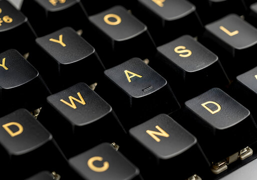 Close up view of a black computer gaming keyboard featuring the prominent wasd keys used for movement in various video games