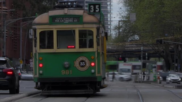 Historic Melbourne Tram at Intersection with Timelapse of Modern City Movement