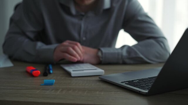 Financial audit.
A bank employee counting money: a close-up of hands rapidly pressing calculator buttons to calculate and count