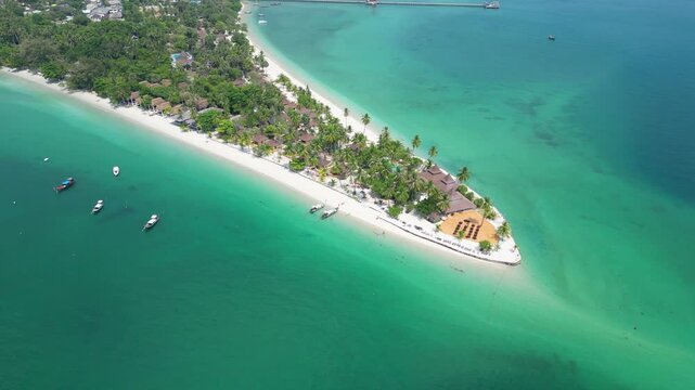 Koh Muk, Thailand: Aerial drone of the famous Koh Mook in the Andaman sea in  Thailand. Shot with an downward and orbit motion around the famous triangle shaped white sand beach and turquoise water. 