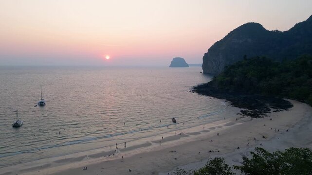 Koh Muk, Thailand: Aerial drone of the sunset over Farang or Charlie beach with sailboat anchored in the Koh Mook in the Andaman sea in Trang province in southern Thailand. 