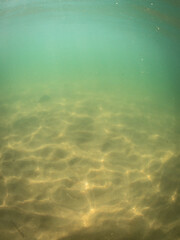 Beautiful light pattern on the sand underwater.