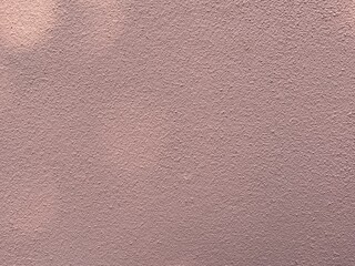 Fototapeta premium Dusty pink plaster wall background with soft matte texture and minimalist aesthetic