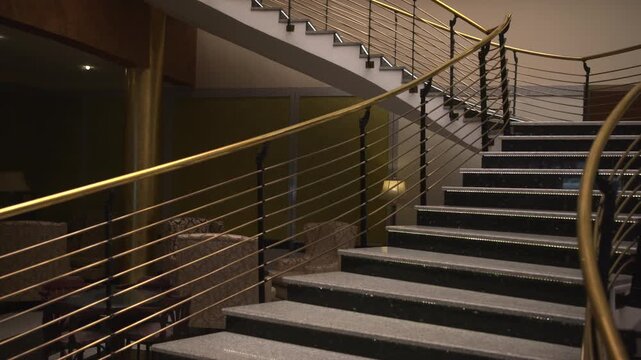 Stylish Hotel Staircase Illuminated Softly With LED Lights And Warm Lamps For Promotional Footage . Media