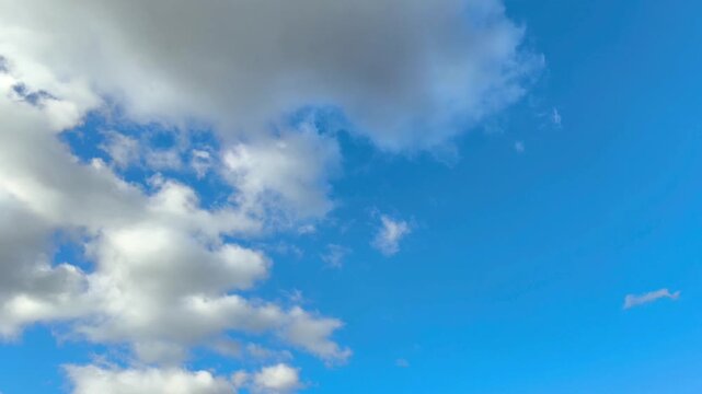 Incredible altocumulus clouds moving in the light blue sky