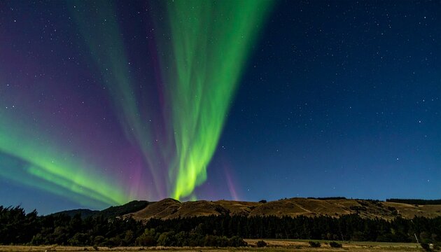 Vibrant Aurora Australis Southern Lights Over Dark Landscape at Night