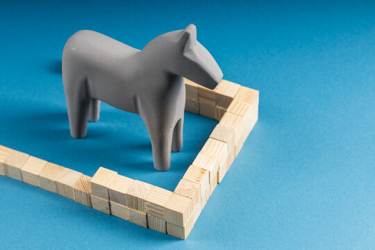 Gray Wooden Toy Horse Stopped by Wooden Fence Obstacle