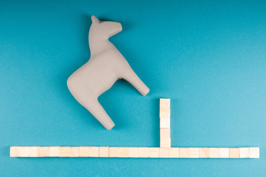 Wooden Toy Horse Stalled by Fence, Overcoming Hurdles in Miniature