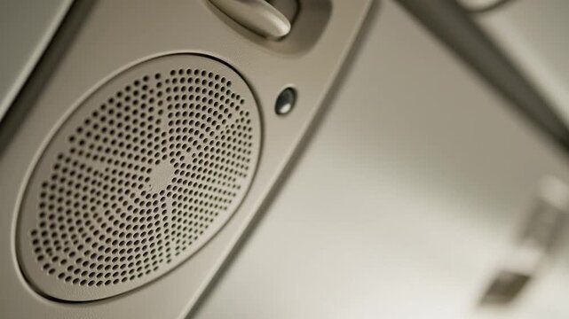 Close-up of audio speaker with illuminated indicator light in modern vehicle interior setting