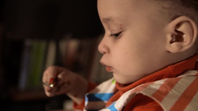 young child is playing with paint