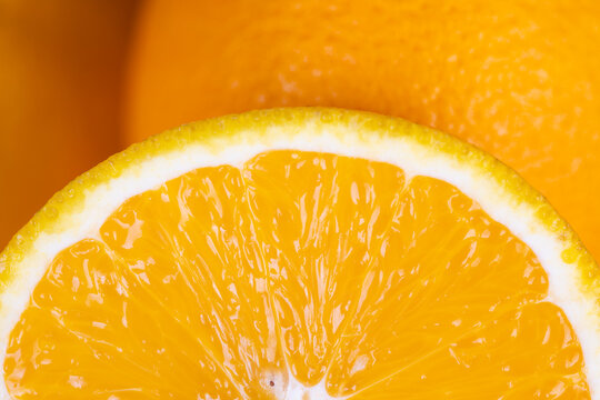 Vivid citrus piece radiating freshness. Brightly lit orange slice full of juice and vitality. Detailed view of ripe orange wedge bursting with juice and radiant sunlight
