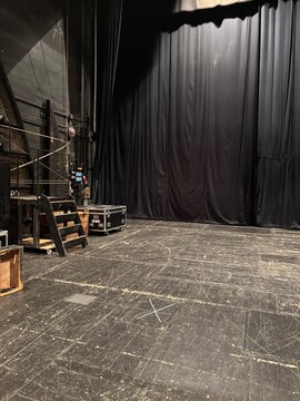Stage background with black curtain and wooden steps in theater  