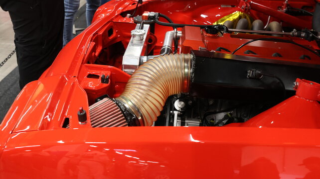 Performance air intake in a clean engine bay with red accents