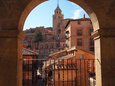 The Cathedral of the Savior and the old town in the arch of the viewpoint on the plaza ayuntamiento in the small sunny village of Albarracin, Aragon, Spain.
