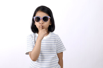 Naklejka premium Indian little cool hipster girl with funny sunglasses in the studio white background showing fashion or summer childhood concept