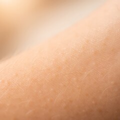 Fototapeta premium Macro shot of smooth human skin surface, highlighting pores, natural texture, and warm neutral tones