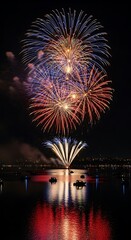 Fototapeta premium Fireworks over dark water.