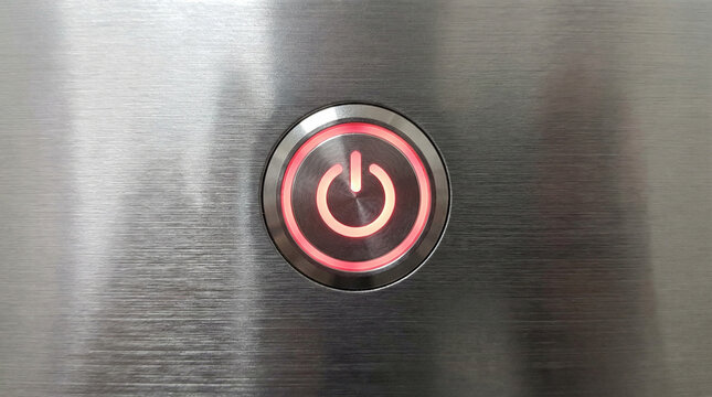Power Button Symbol Glowing Red Standby Technology. Iconic power button symbol glowing intense red against brushed aluminum surface