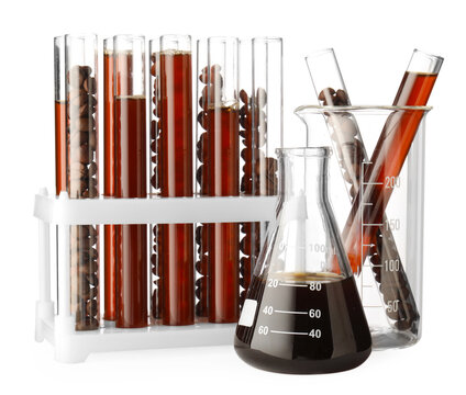 Fresh coffee and beans in laboratory glassware isolated on white
