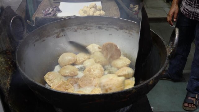 Puri or poori frying in hot oil 4k footage 