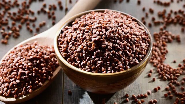 Bowl of buckwheat kasha on wooden table.