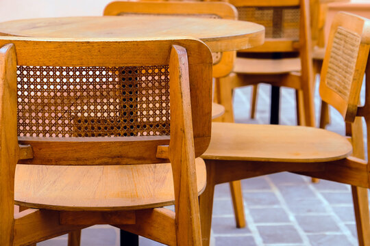 Detail image of Wicker chairs and table in a coffee shop. Furniture made of rattan.