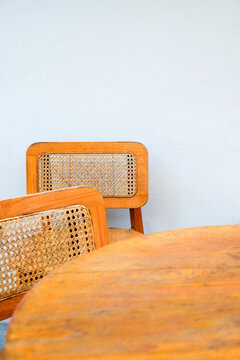 Detail image of Wicker chairs and table in a coffee shop. Furniture made of rattan.