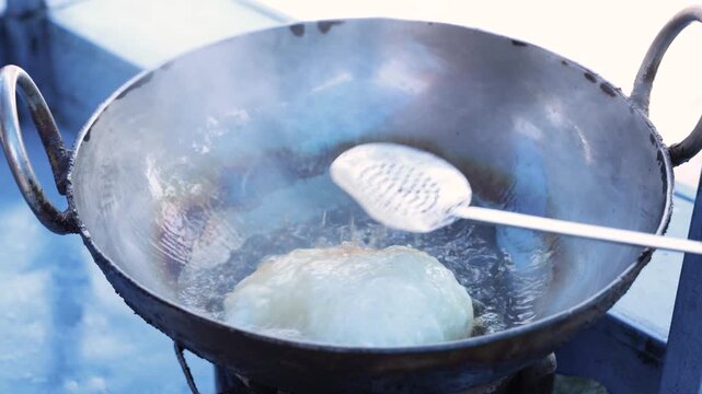 Bhatura frying in hot oil 4k footage 