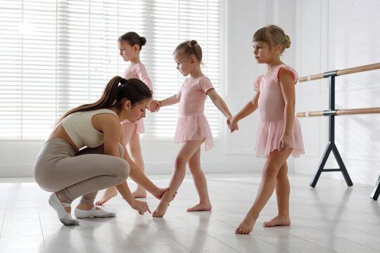Ballet teacher having class with children in dance studio