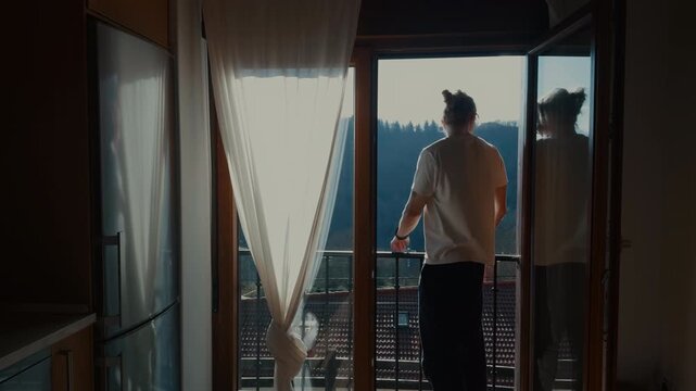 Man smiling at window enjoying morning sunlight cozy home scene
Close lifestyle moment of man looking outside window with warm sunlight and calm mood.