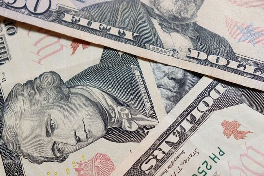 100 US Dollar bills Franklin close-up. Pyramid shape of stacked US Dollar bills. 