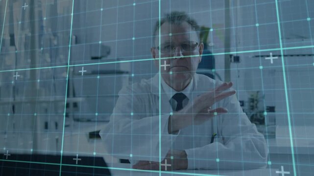 Senior scientist raising right hand and sweeping holo grid shifting and adjusting clinical data