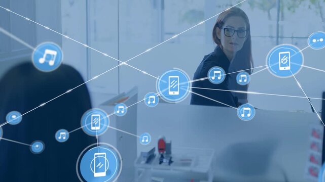 Woman turning to track overlay in office as glowing phone icon sparking mobile icons for business