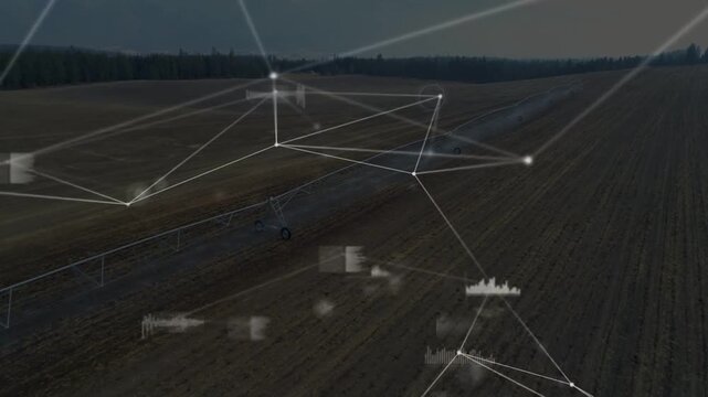 Digital HUDs fading, drone tracking center-pivot arm and wheel across tilled field monitoring soil