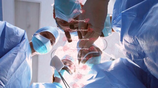 Surgery team leaning over eye under lamp asst placing spatula scalpel cutting pink overlay moving