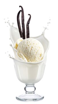 Creamy vanilla ice cream scoops within a milk splash, vanilla beans, and glass
