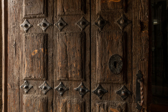 Old wooden door detail at Romanesque Church of Saint John in Avila, Spain.