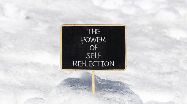 Self reflection symbol. Concept words The power of self reflection on beautiful black blackboard. Beautiful white snow background. Business the power of self reflection concept. Copy space.