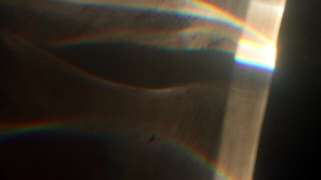 Moving Abstract Bokeh Spectrum Light, lens flare, leaking reflection of glass, crystal, defocused multicolor rainbow rays background