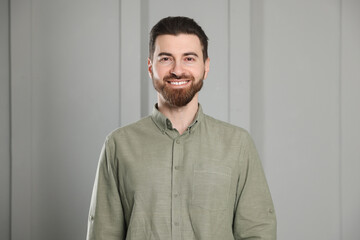 Obraz premium Portrait of handsome man near white wall indoors