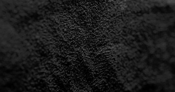 Abstract black texture. The slow, smooth diagonal movement of a dark, rough surface moving.