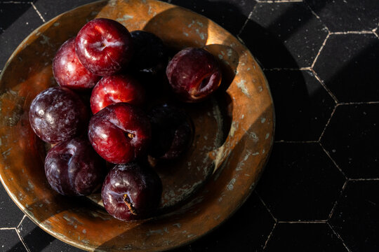 Plums on a dark surface 
