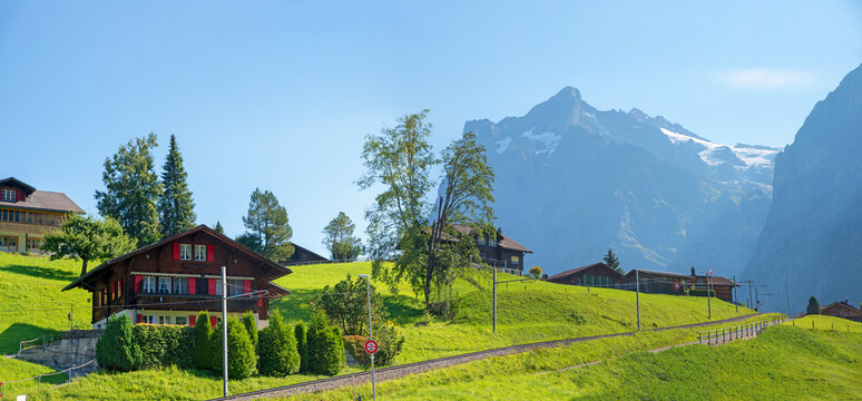pictorial landscape tourist resort Grindelwald, wetterhorn mountain, railroad and houses
